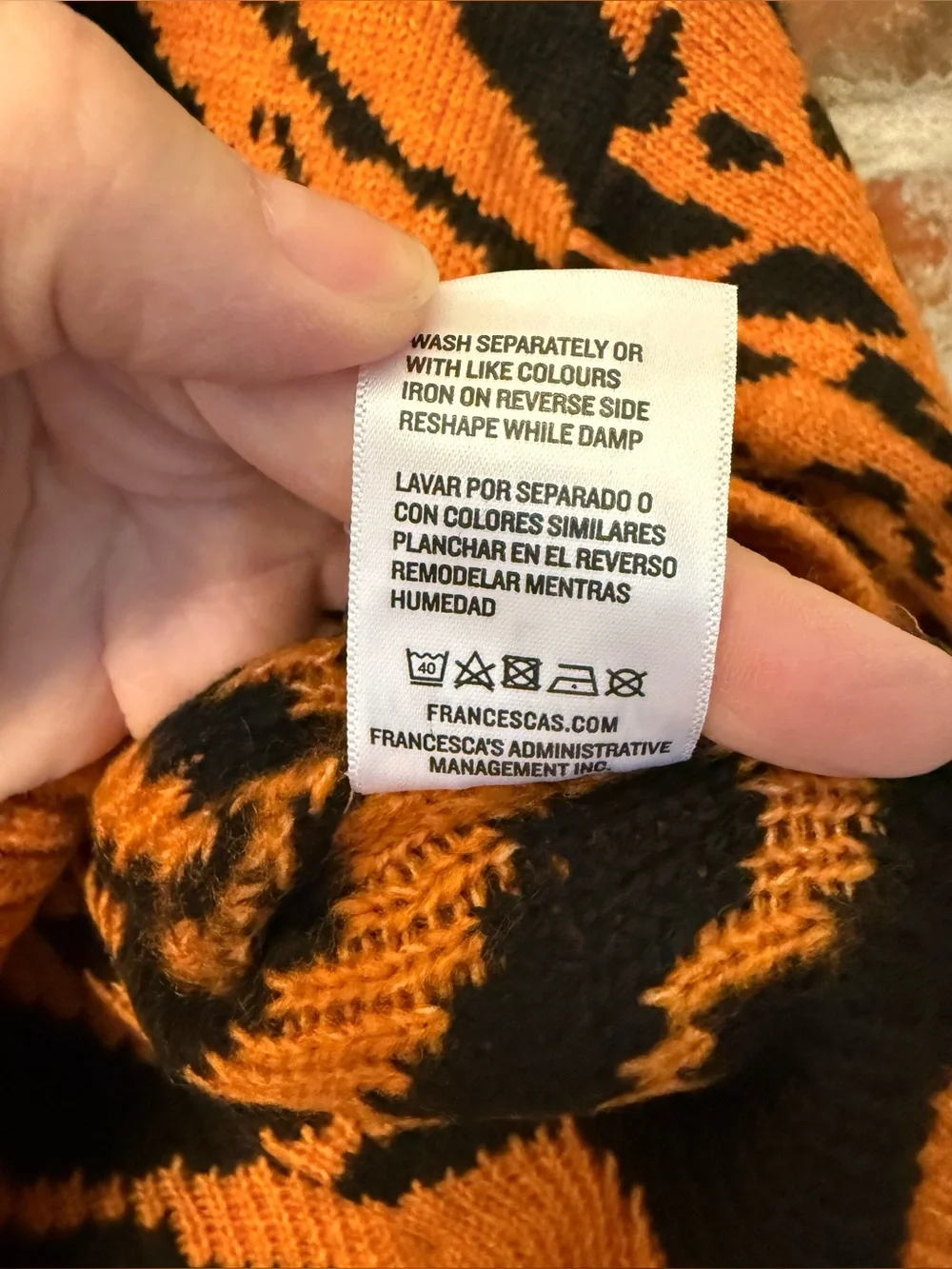 S46 - Francesca's Collections Orange and Black Animal-Print V-Neck Sweater
